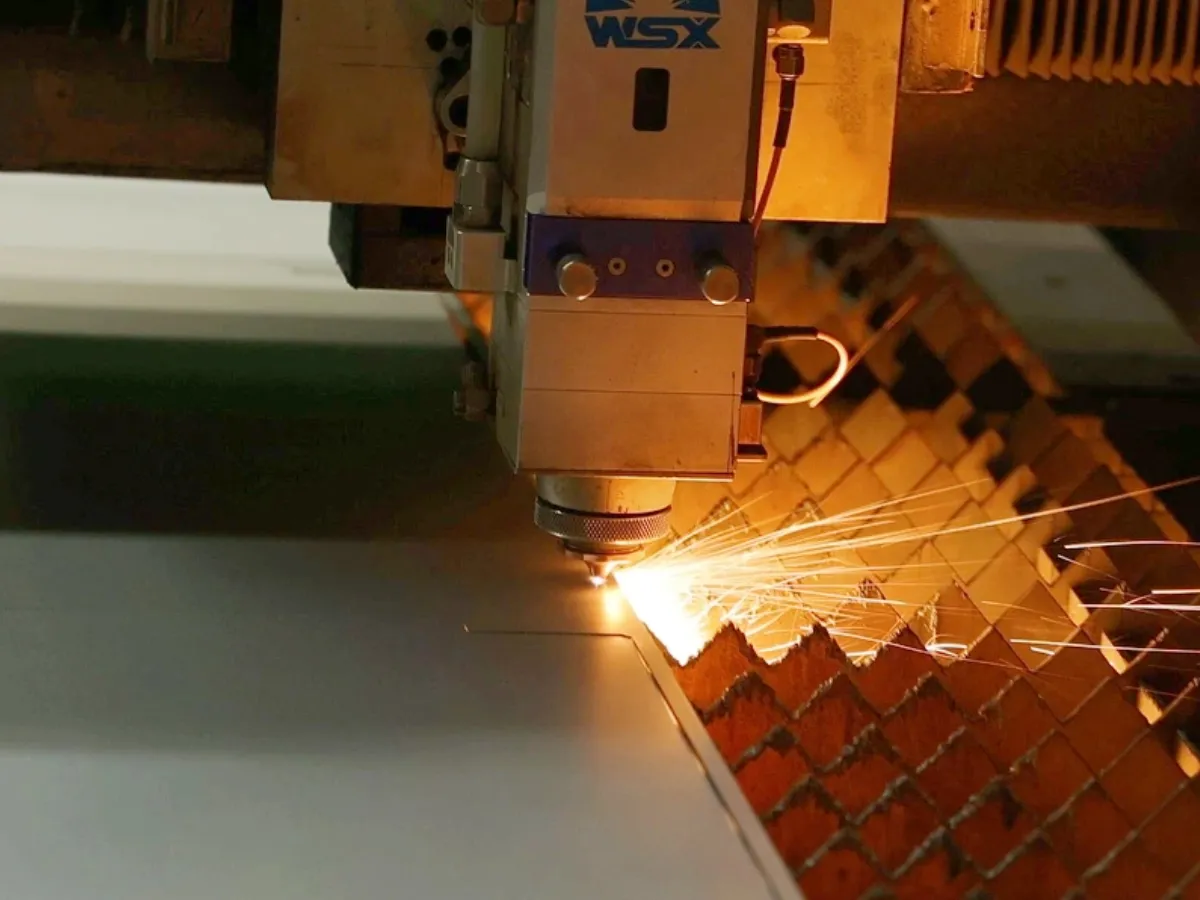 Close-up of fiber laser cutting sparks on steel sheet