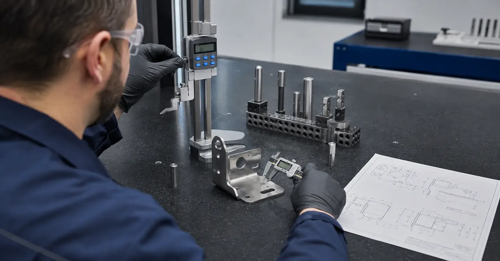 Stamping Tolerance Inspection Inspector measuring stamped bracket against an engineering drawing
